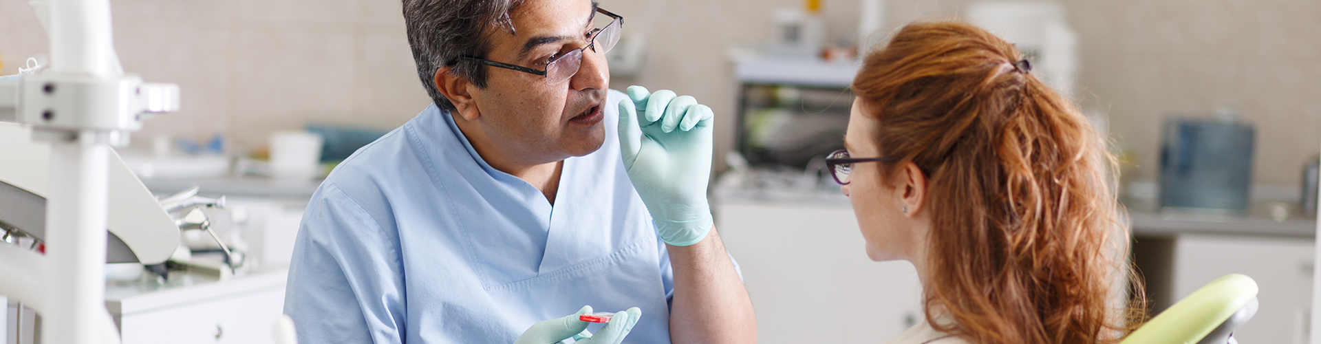 A dentist explaining something to a patient.