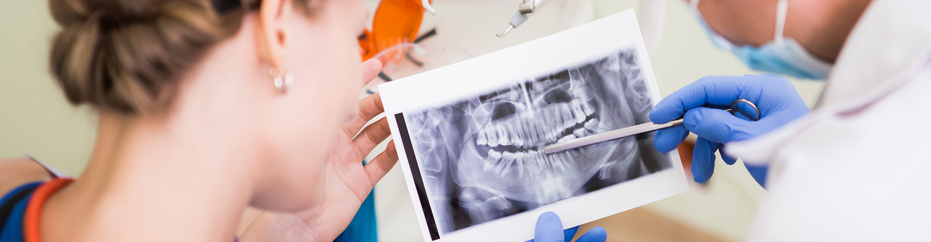 Dentist showing patient x-ray of her teeth.